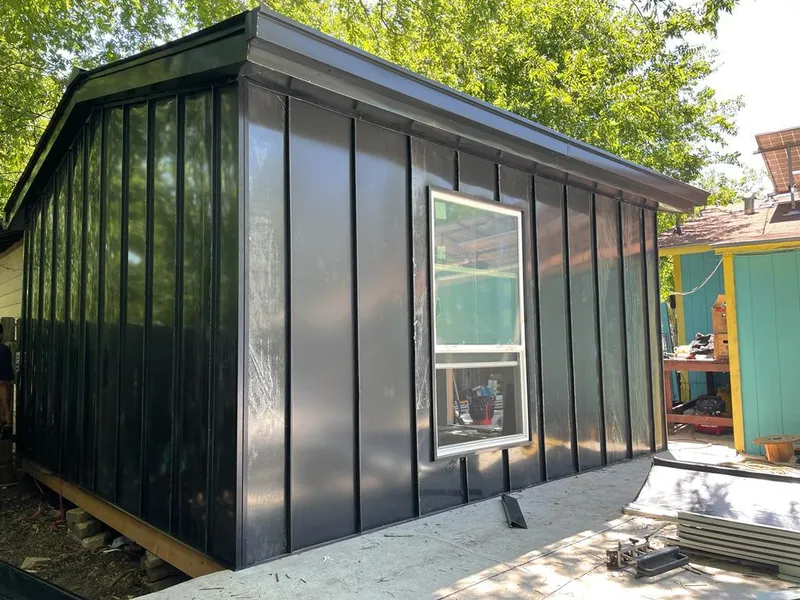 Black standing seam metal wall panels for Roof Inspection in Johnson Lane