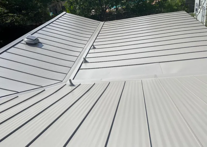 Solar attic fan installed on a metal roof for Roof Ventilation in Johnson Lane